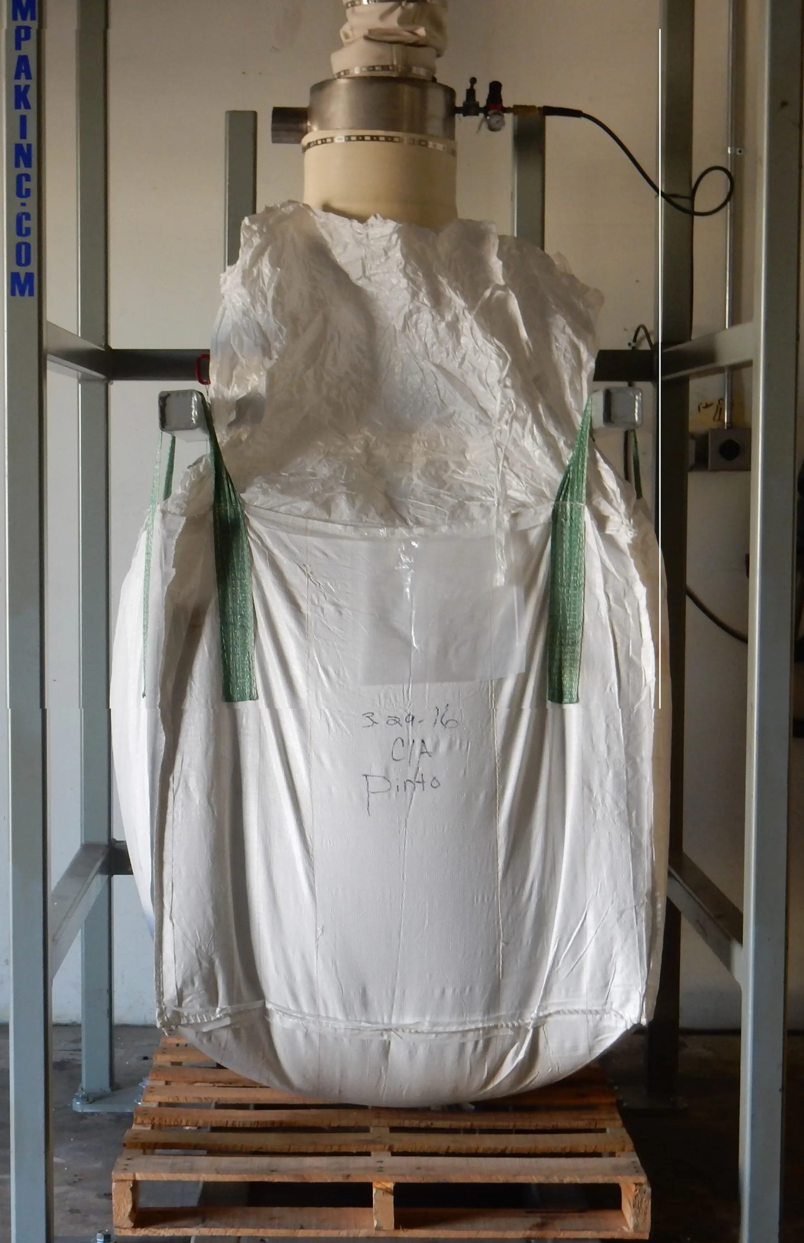 bulk bag on wooden crate connected to filling station